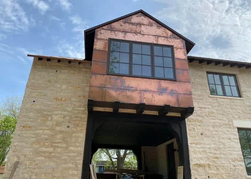 Copper metal panel facade on a stone building for Roof Repair in Wilmington Manor